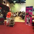 An event at Bingley Little Theatre showing people seated at tables and getting refreshments next to a pop up banner